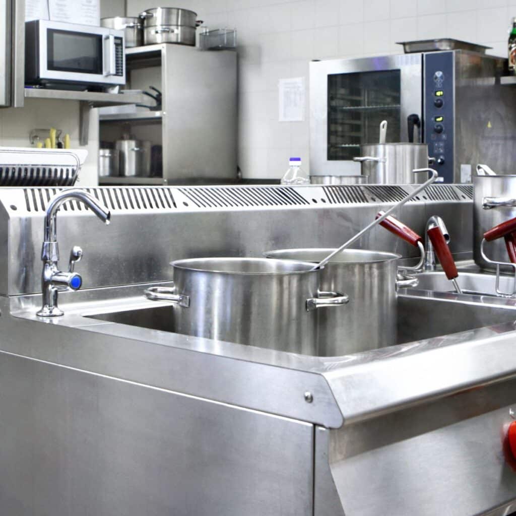 commercial sink with dishes waiting to be washed