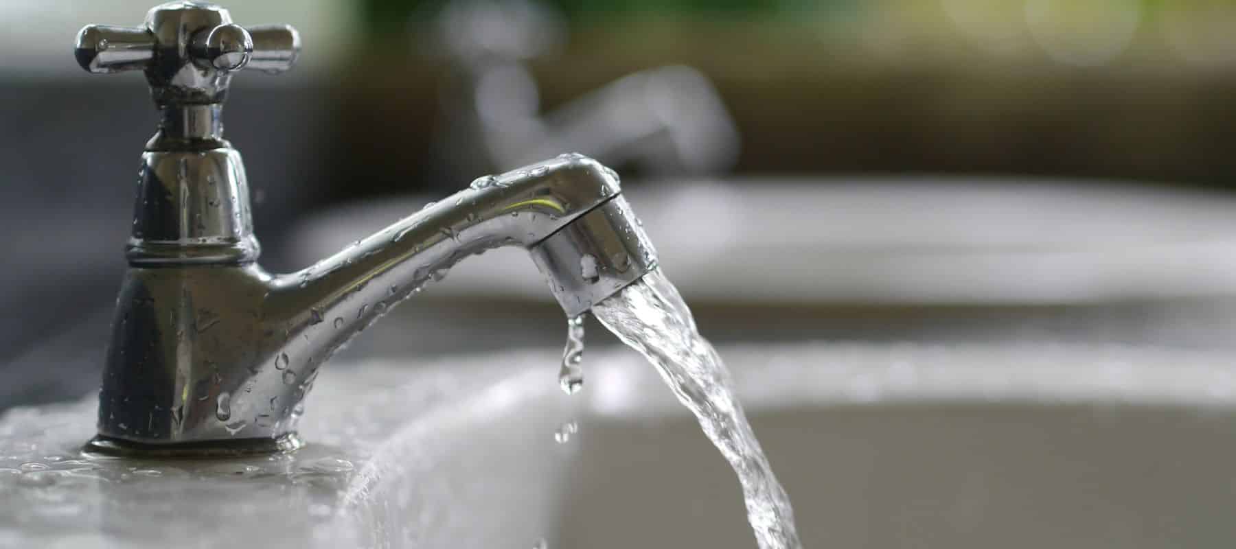 closeup of faucet with water pouring out of it